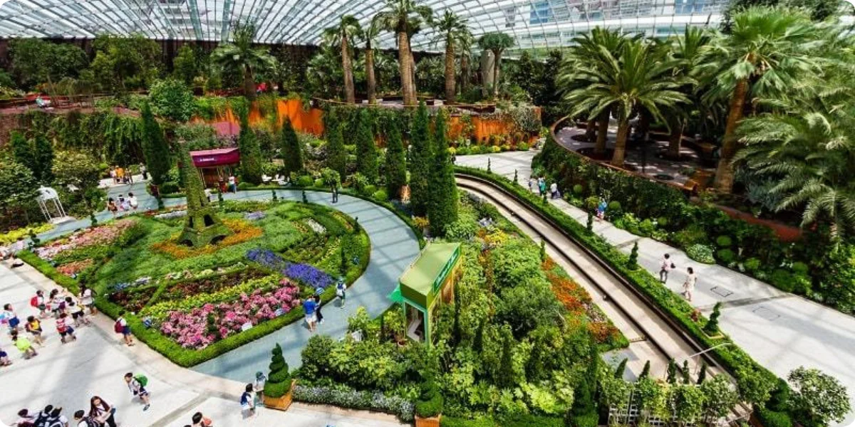 A panoramic view of Gardens by the Bay in Singapore, showcasing its iconic Supertree Grove and lush greenery.