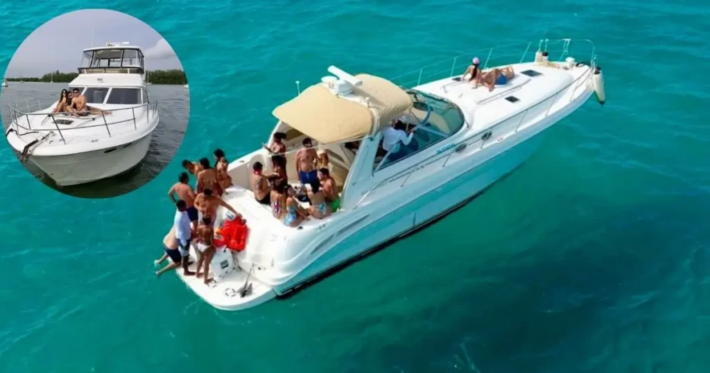 A group of friends on a private yacht rental in Miami, with some sitting on the deck and others dipping their feet in the turquoise water.
