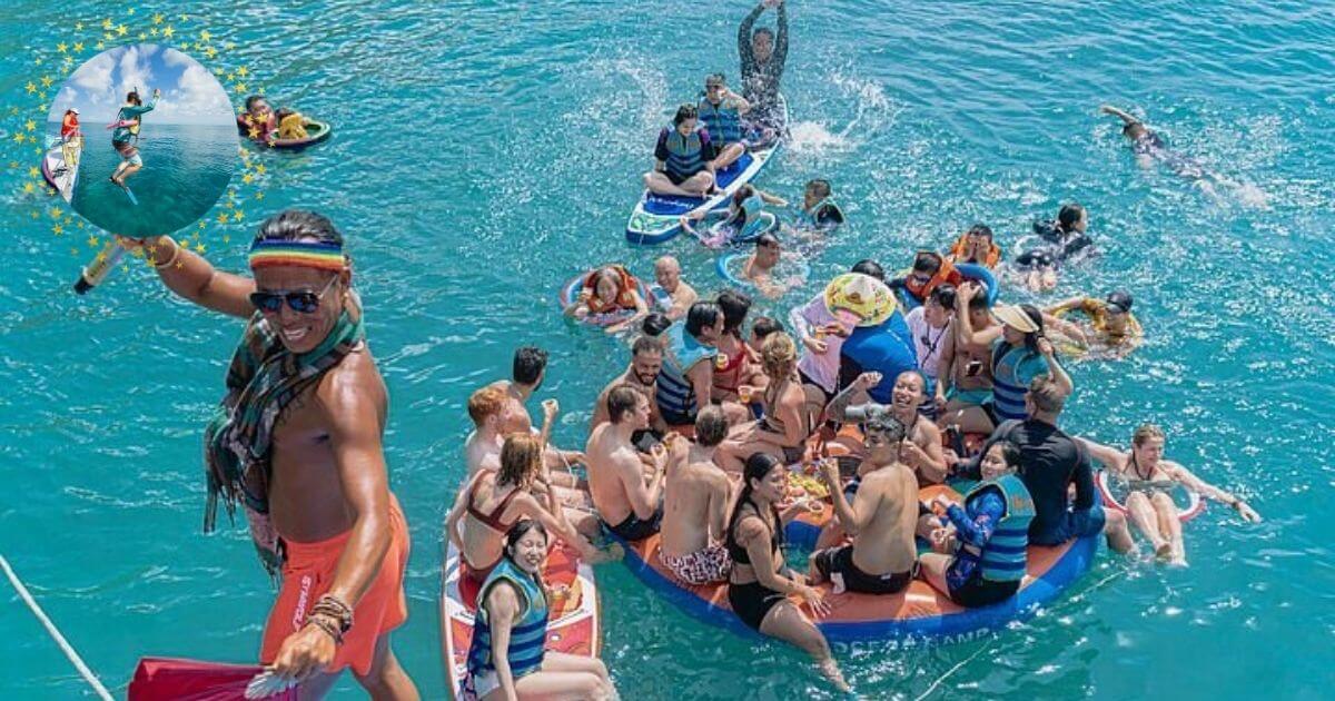 A large group of people on an inflatable raft and floating in the clear blue ocean. An inset shows a person snorkeling.