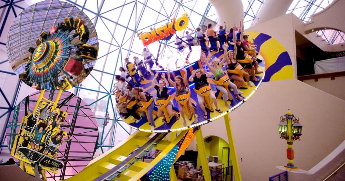 A photo of the interior of the Adventuredome at Circus Circus in Las Vegas, showing a roller coaster track, various rides, and a crowd of people under a large pink glass dome. An inset shows a family riding a roller coaster.