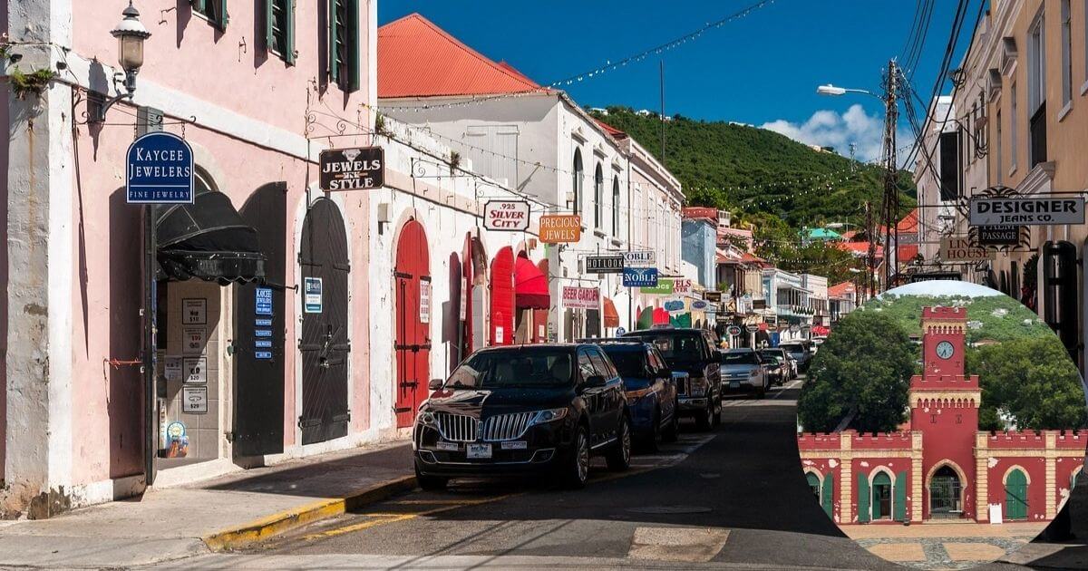 A street view of historic Charlotte Amalie in the U.S. Virgin Islands, showing shops with colorful buildings and parked cars. An inset shows the iconic red brick building of Fort Christian.