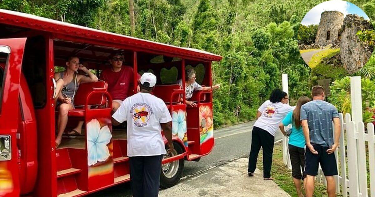 A group of tourists getting off a red, open-air bus during a guided tour of St. John. An inset shows the ruins of the historic Annaberg Plantation.