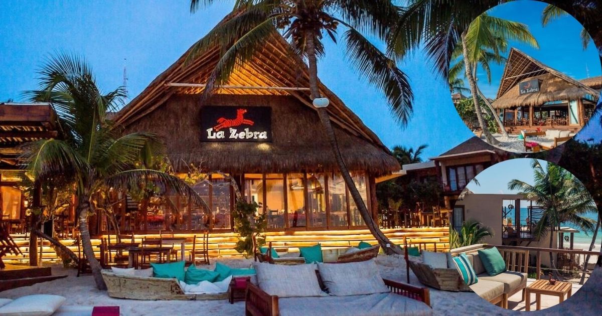 The vibrant, thatched-roof beachfront bar and restaurant at La Zebra Tulum, with casual seating, ambient lighting, and palm trees on the sandy shore.