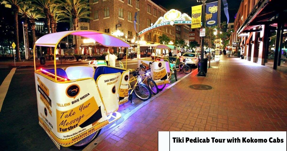 A brightly lit Tiki pedicab from Kokomo Cabs parked on a city street at night, ready for a tour.