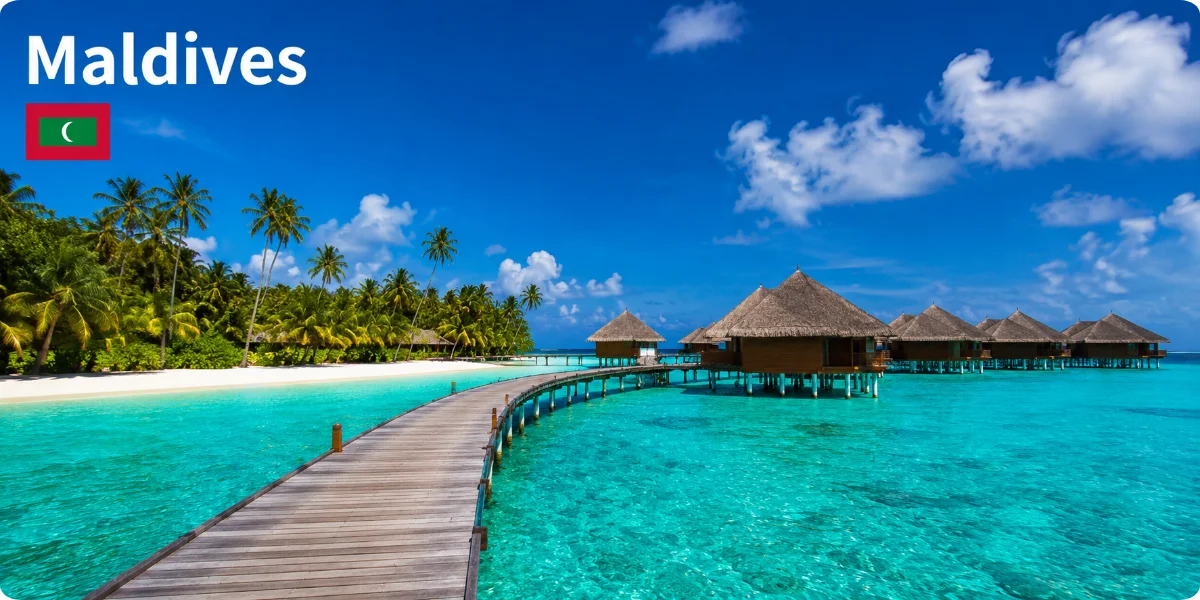 A picturesque Maldives landscape featuring clear blue skies, vibrant coral reefs, and tranquil beach resorts for travelers.