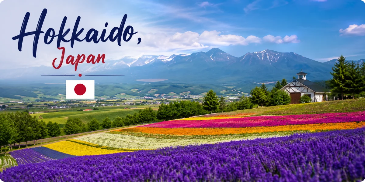 Hokkaido, Japan, scenic flower fields with mountains and Japanese flag
