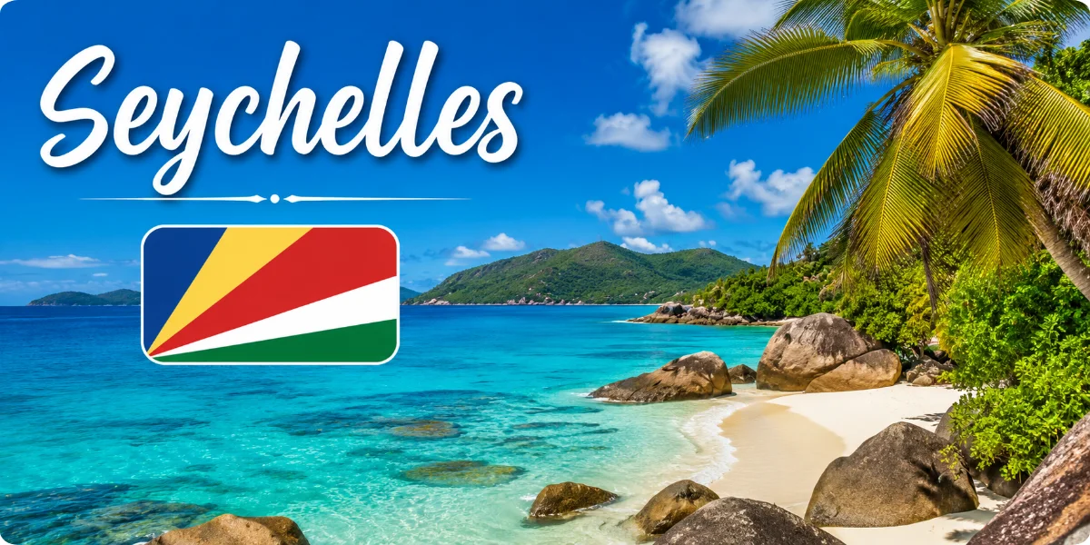 Seychelles tropical beach with turquoise water, granite rocks, palm trees, and Seychelles flag.
