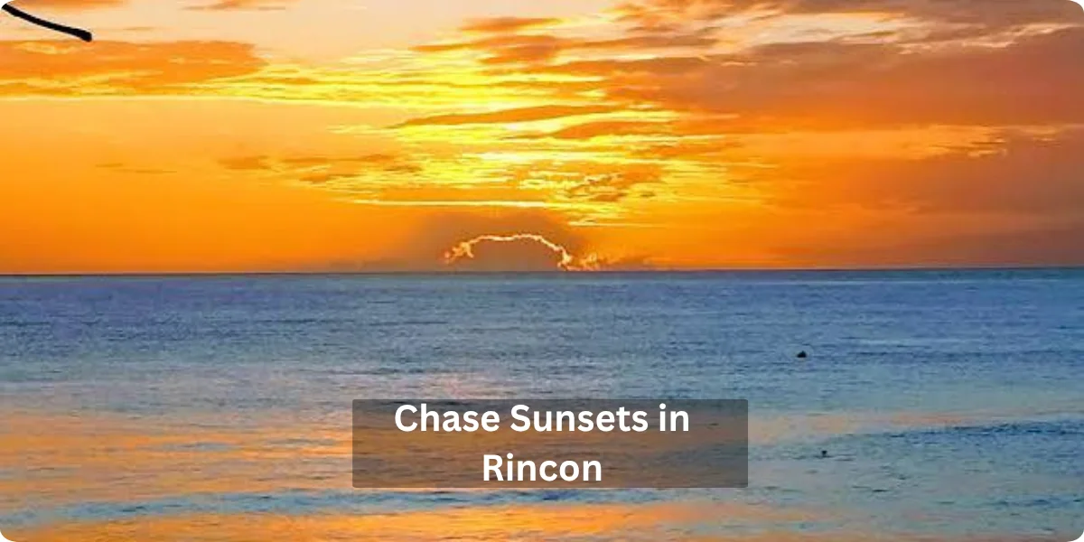 A vibrant sunset over the ocean in Rincon, with hues of orange, pink, and purple reflecting on the water's surface.