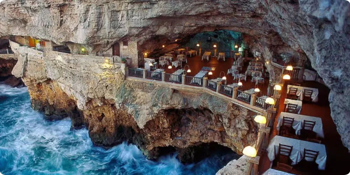 A cave restaurant in Polignano a Mare, featuring stunning ocean views and natural rock formations.