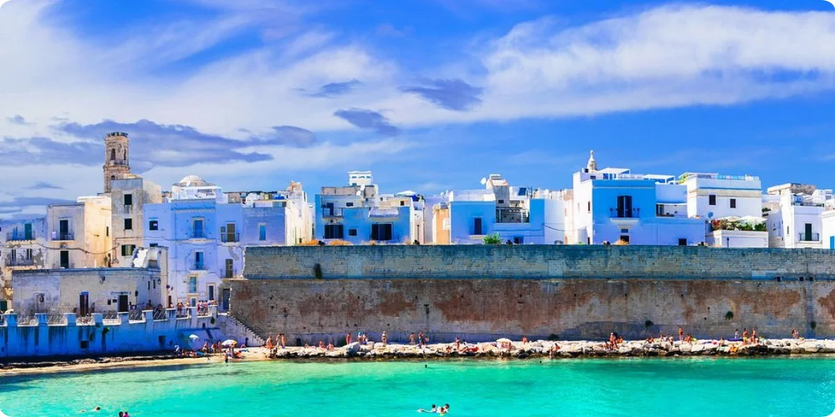 A blue and white building stands against a clear blue sky, showcasing a vibrant architectural design.