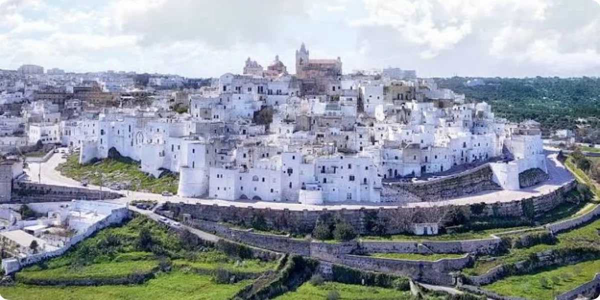 The White City, and it earns the name every building is limewashed to a near-glow, a tradition originally meant to reflect heat and, as legend has it, help ward off plague.