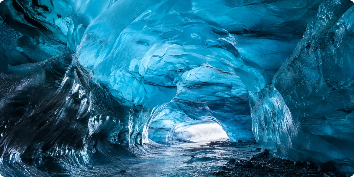 A stunning blue ice cave in Iceland, showcasing intricate ice formations and a serene, ethereal atmosphere.