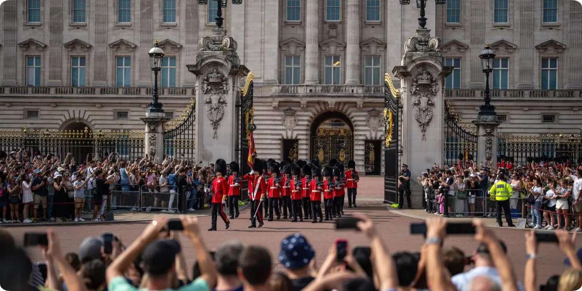 King's Guard in red uniforms during the Changing of the Guard at Buckingham Palace.